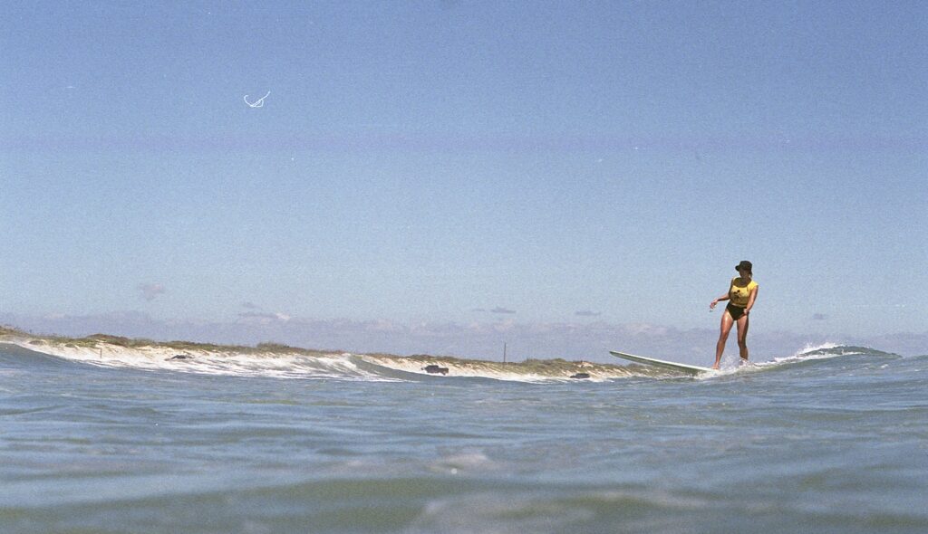 Needles & Fins owner Rachel Chaney surfs in Corpus Christi, Texas. 