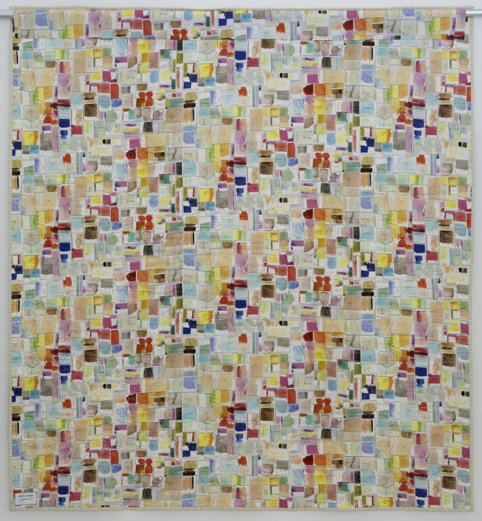A patchwork quilt of multicolored fabric.