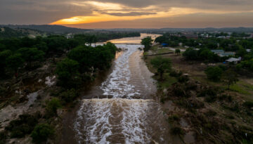 In an aerial view, the sun sets over the Guadalupe River on July 06, 2025 in Kerrville, Texas. Heavy rainfall caused severe flooding along the Guadalupe River in central Texas, leaving more than 80 people reported dead.