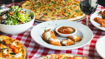 A spread of pizza and other dishes at Mozzafiota Pizza.