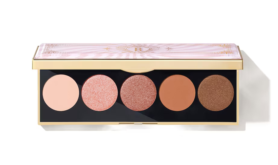 An open eyeshadow palette from Bobby Brown with five brown and pink neutral shades on display.