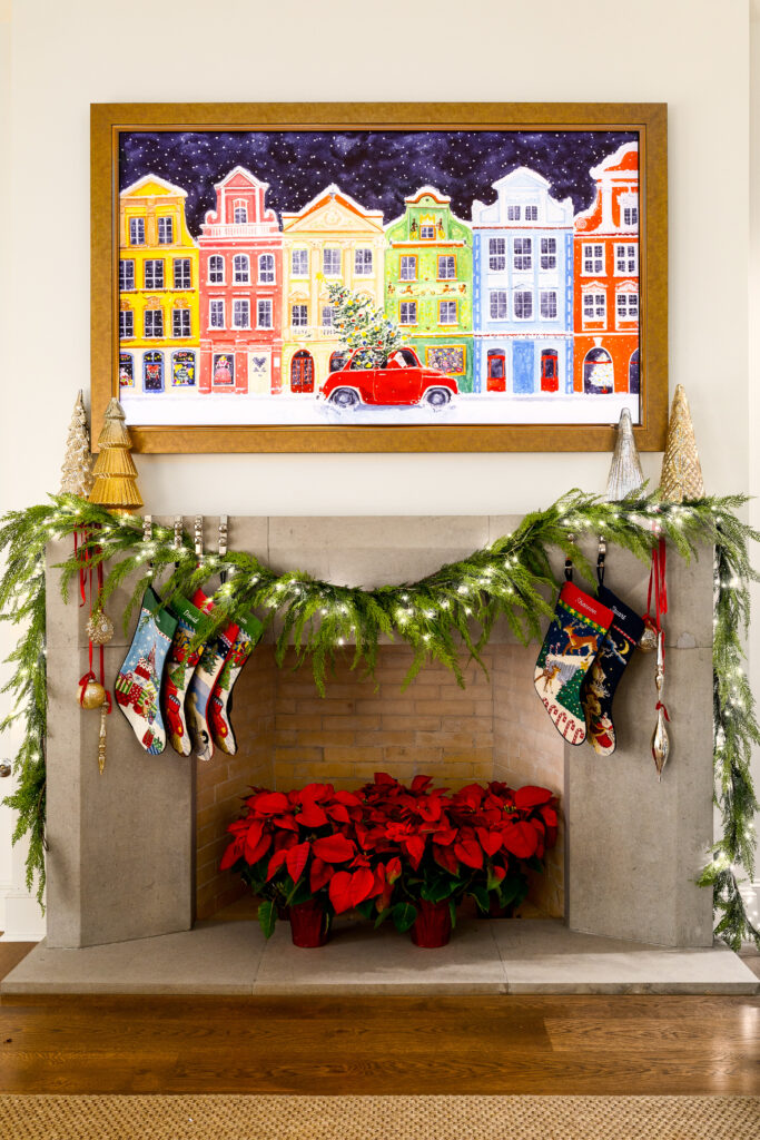 Stuart and Shannon White's fireplace, decorated with Christmas stockings, faux greenery and poinsettas.