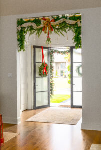 The entrance of Stuart and Shannon White's home decorated with holly, mistle toe and a holiday wreath.