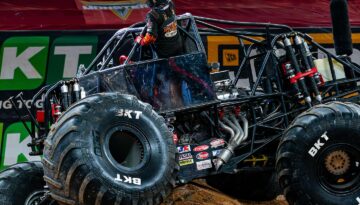 Berto Treviño sticks out of his Monster Jam truck Monster Mutt Rottweiler inside the arena.