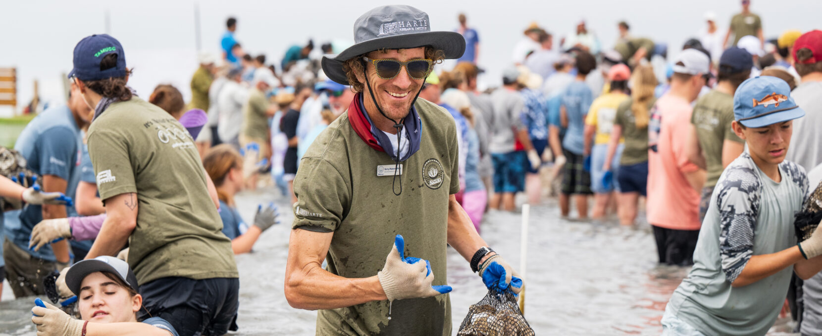 Senior Research Scientist Dr. Terry Palmer smiles at the camera during a recent Sink Your Shucks bagging event