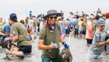 Senior Research Scientist Dr. Terry Palmer smiles at the camera during a recent Sink Your Shucks bagging event