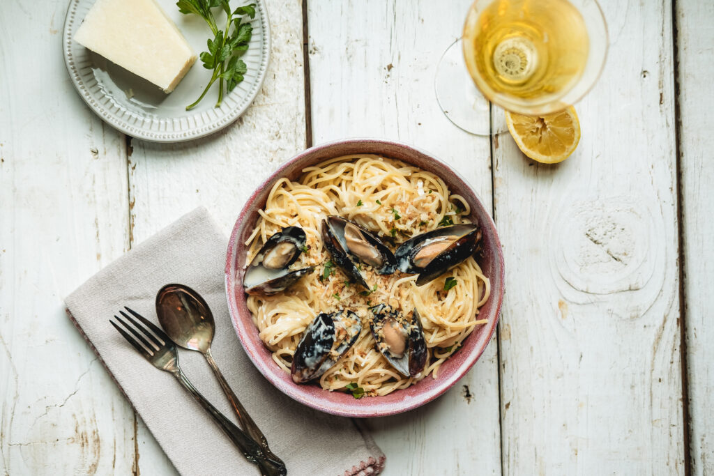 An overhead image of February 2026's Creamy Pasta with Mussels and Toasted Breadcrumbs recipe.