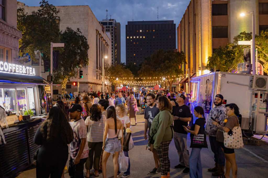 A crowd at ArtWalk gathers around food trucks in downtown Corpus Christi.