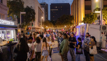 A crowd at ArtWalk gathers around food trucks in downtown Corpus Christi.