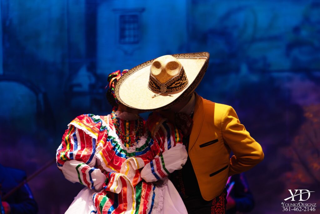 Dancing partners from Alcorta's Compañía de Danza Folklórica pose on stage in Corpus Christi, Texas. 